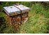 A photo of a bee box. Countless bees are swarming around in this photo.