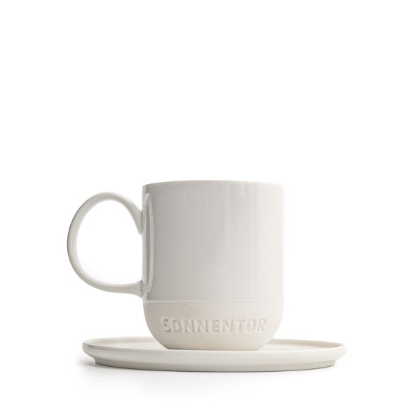 The photo shows a white SONNENTOR porcelain espresso cup with saucer and lettering. The cup holds 62.5 ml!