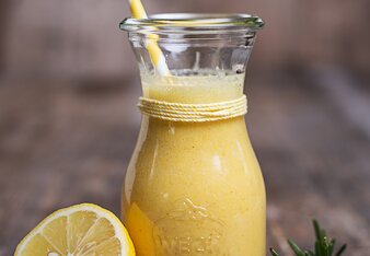 Auf dem Foto ist eine Karaffe mit Kurkuma Detox Smoothie zu sehen. Daneben sieht man eine halbe Zitronenscheibe. | © SONNENTOR