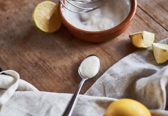 Auf dem Foto ist eine Schale mit Mayonnaise zu sehen. Darauf liegt ein Schneebesen. Daneben sind ein Löffel und Zitronenstücke zu sehen. | © SONNENTOR